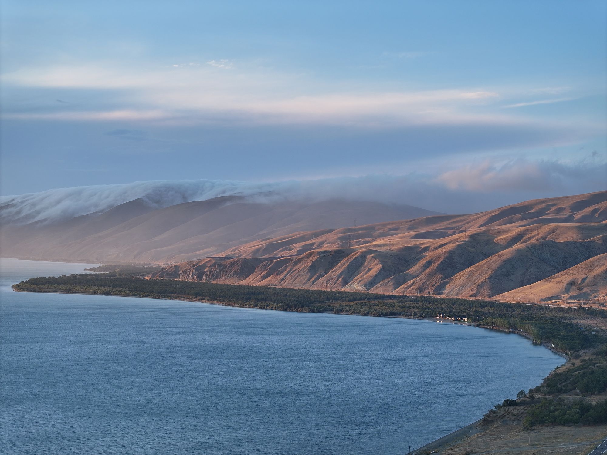 Lake Sevan, east shore, with clouds spilling over the mountains