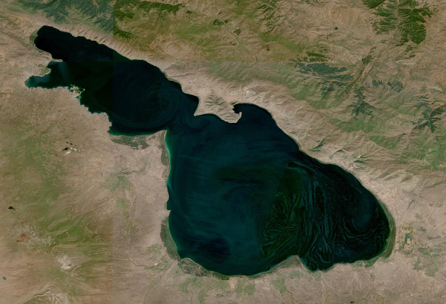 Satellite view of Lake Sevan with green swirls of algae, 18 August 2025
